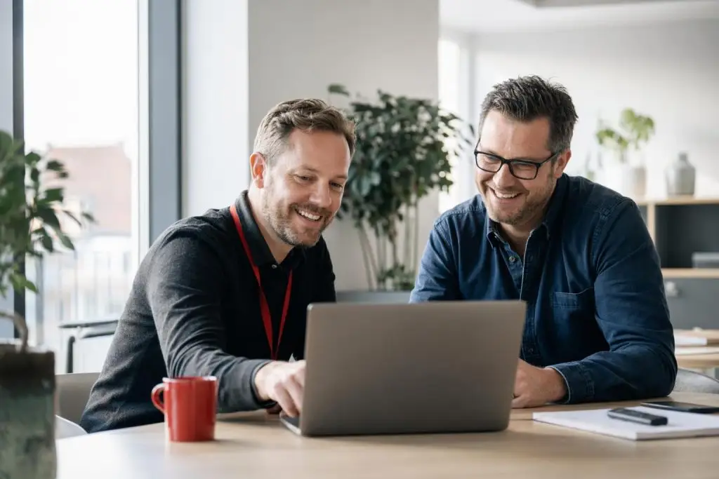 IT-konsulent fra A-ONE Solutions giver personlig rådgivning til kunde på moderne kontor